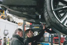 A mechanic inspecting an electric car